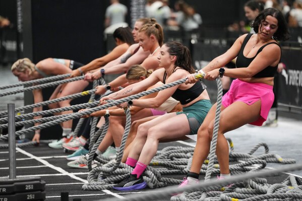 Women compete in a HYROX fitness challenge at the health & fitness trade show FIBO in Cologne, Germany, Friday, April 17, 2026. (AP Photo/Martin Meissner)