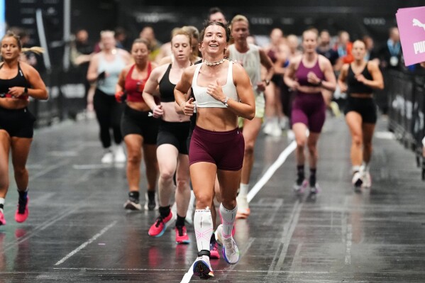 People compete in a HYROX fitness race at the health & fitness trade show FIBO in Cologne, Germany, Friday, April 17, 2026. (AP Photo/Martin Meissner)