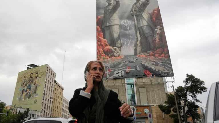 A woman talks on her cellphone in downtown Tehran, Iran, Monday, April 20, 2026. 