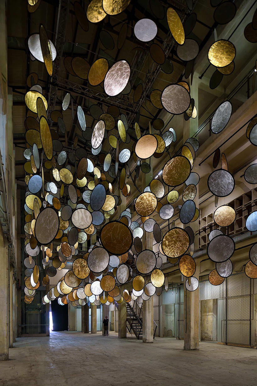 SpY’s kinetic installation suspends rotating gold and silver halos inside florence atrium - 3