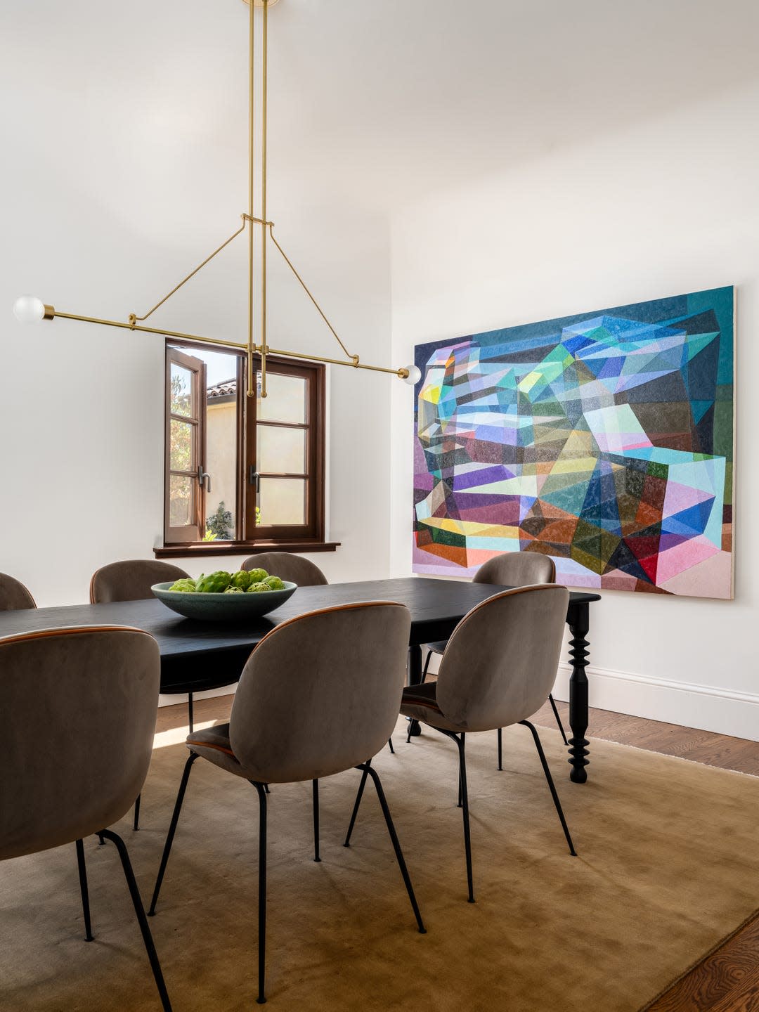 Modern dining area with an artistic wall decoration.