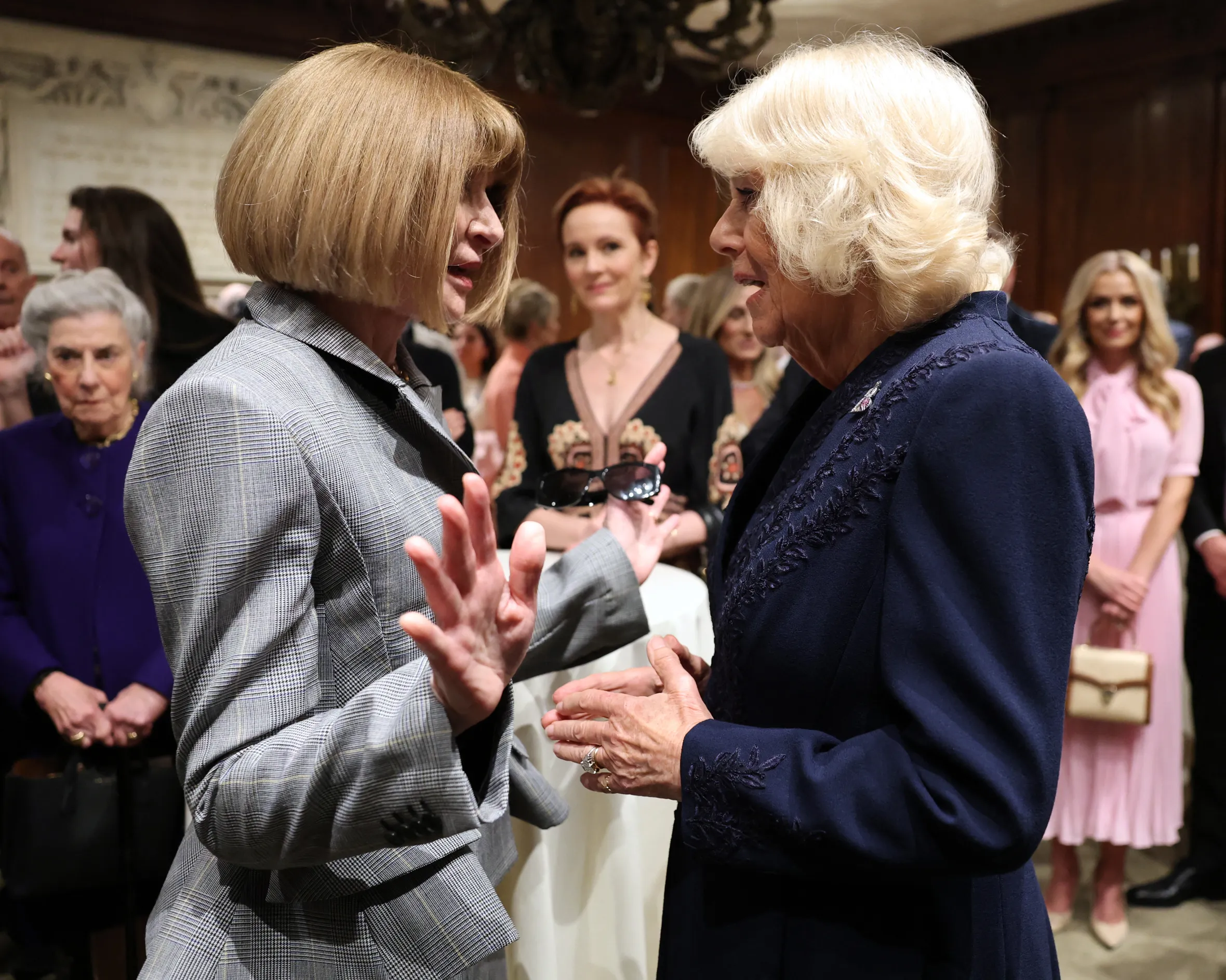 Queen Camilla of Britain speaks with Anna Wintour at a literacy event.