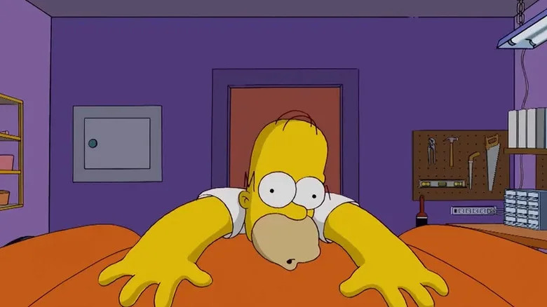 Homer Simpson lays across the hood of his car during the opening title sequence of The Simpsons