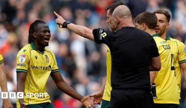 Wrexham's Issa Kabore (left) protests with referee Robert Madley