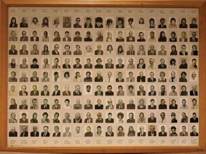 A framed collage of over 100 small, individual black-and-white portraits, each featuring a person in formal attire, arranged in a grid pattern with names or labels beneath each photo.
