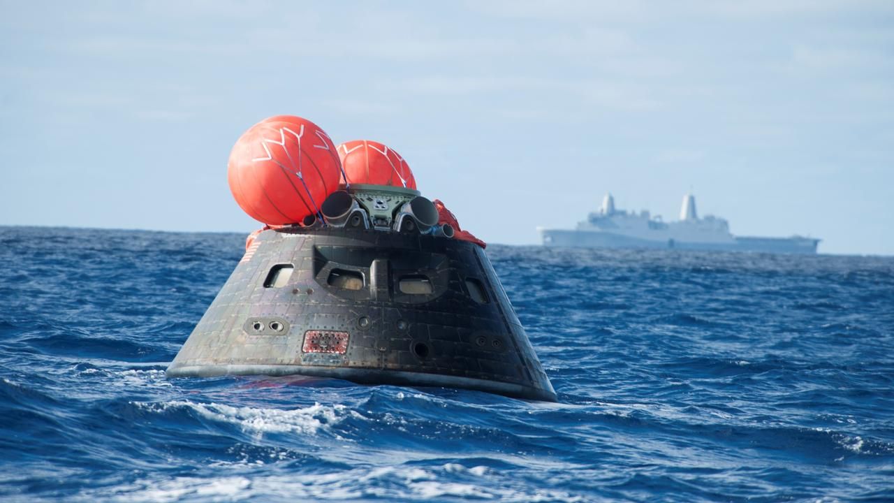 orion spacecraft floating on the ocean.