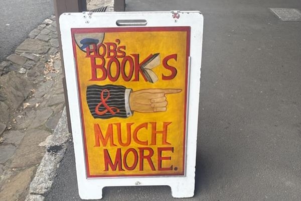 An a-frame sign reading 'Bob's books, and much more' 