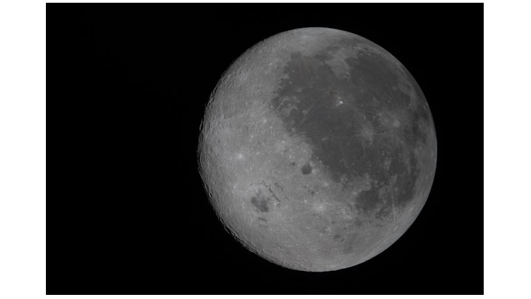 A new photo captures the moon's near side on the right (the side we see from Earth, identifiable by its dark splotches) and its far side on the left. The Artemis 2 crew are the first to see the far side with human eyes.