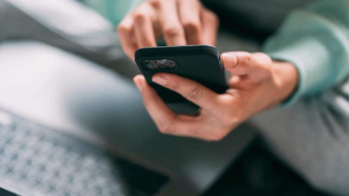 A person scrolling on a smartphone screen.