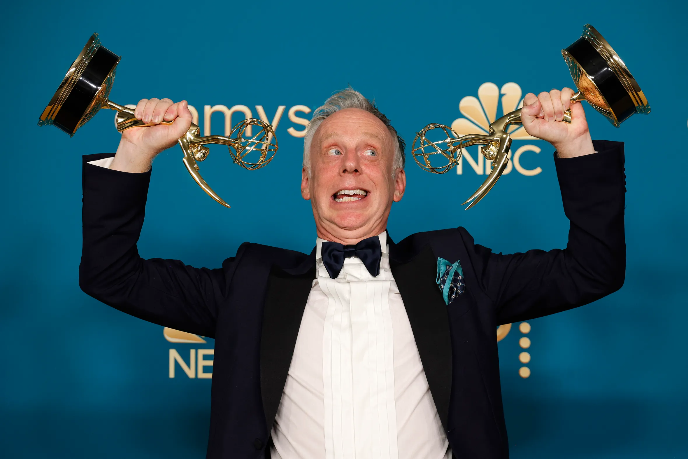 Mike White holding two Emmy awards for "White Lotus."