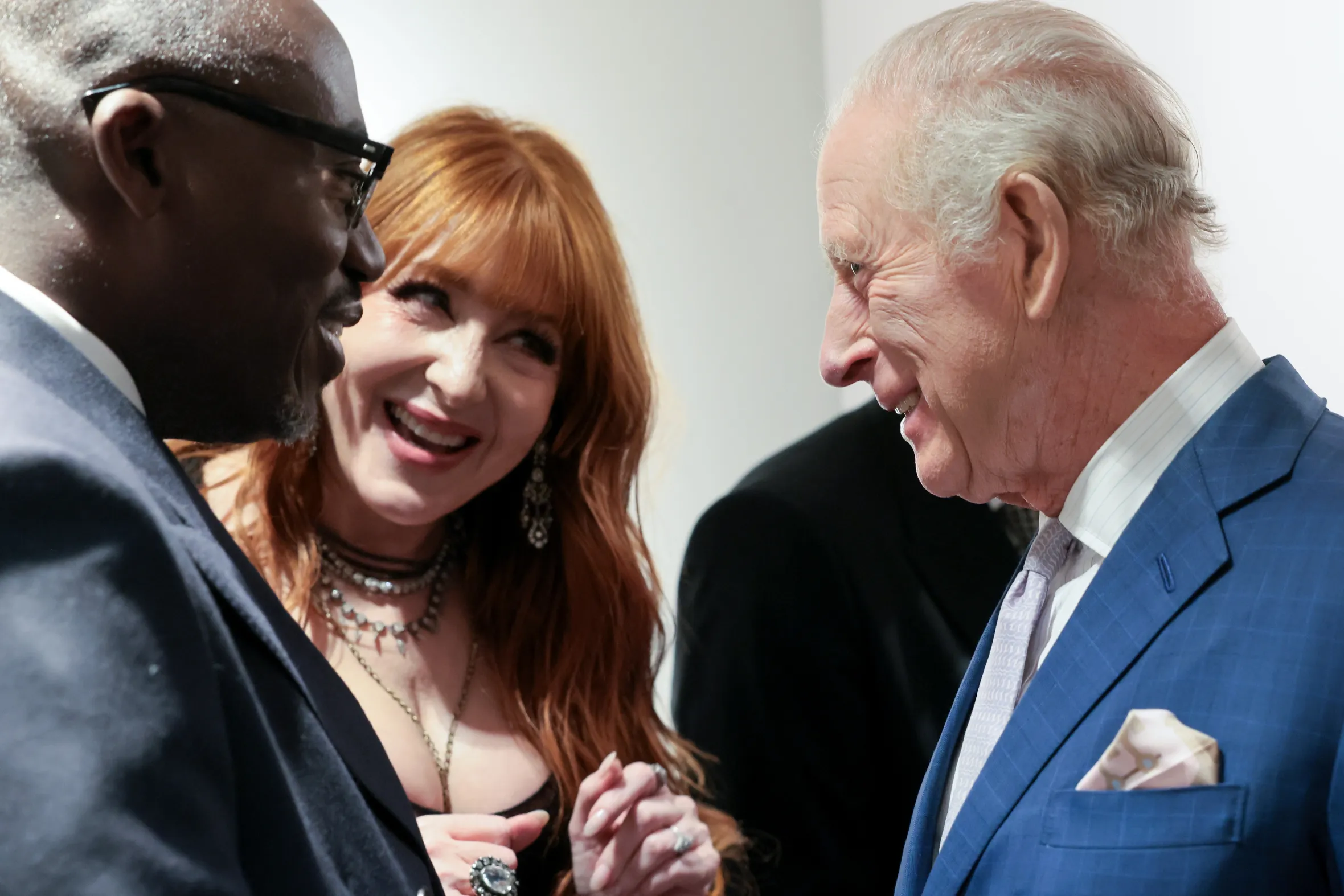 King Charles III speaking with Edward Enninful and Charlotte Tilbury at a cultural reception.