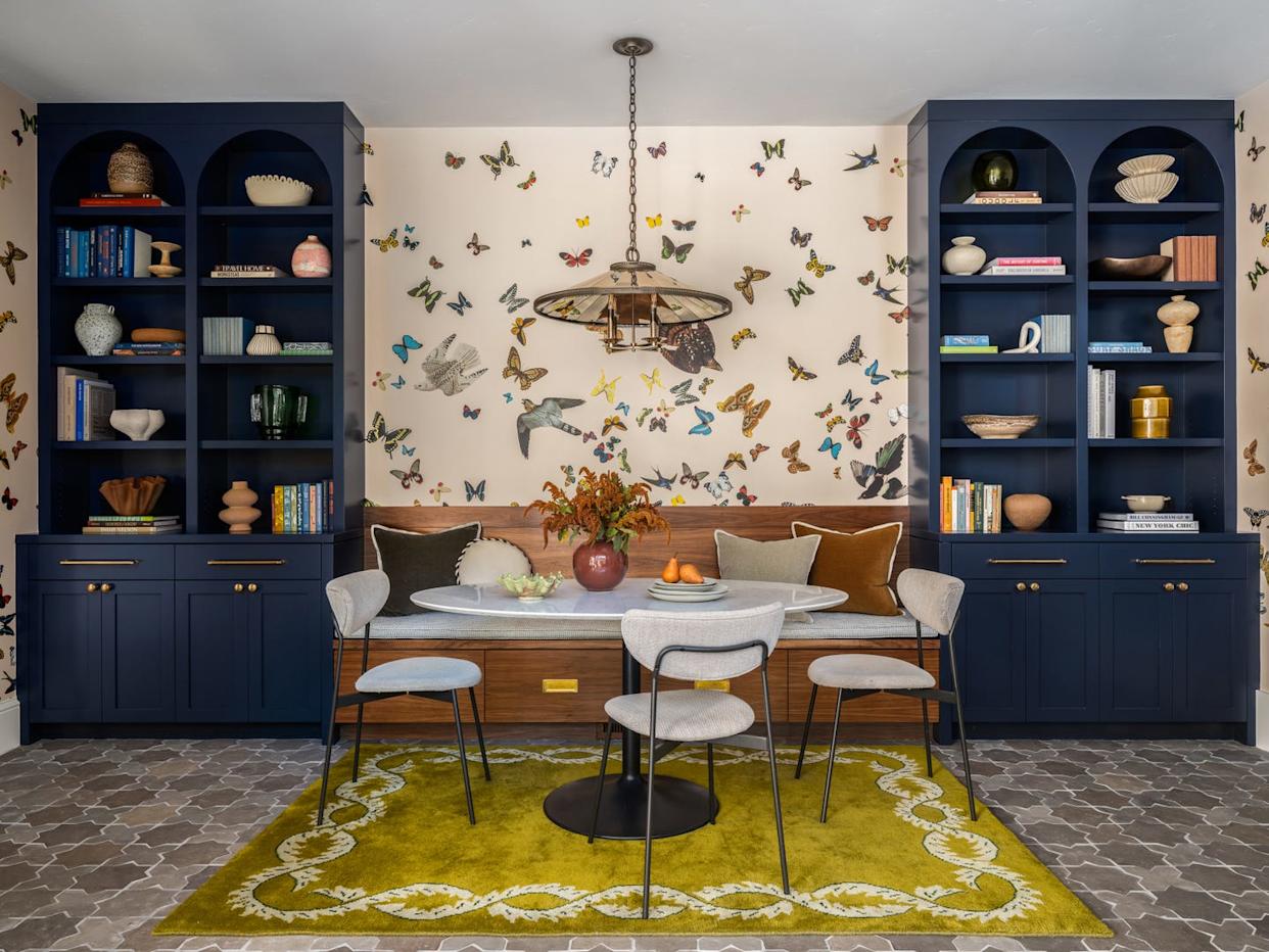 Dining area featuring a round table, chairs, and decorative shelves.