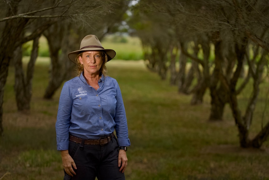 Woman standing in a field of tea trees
