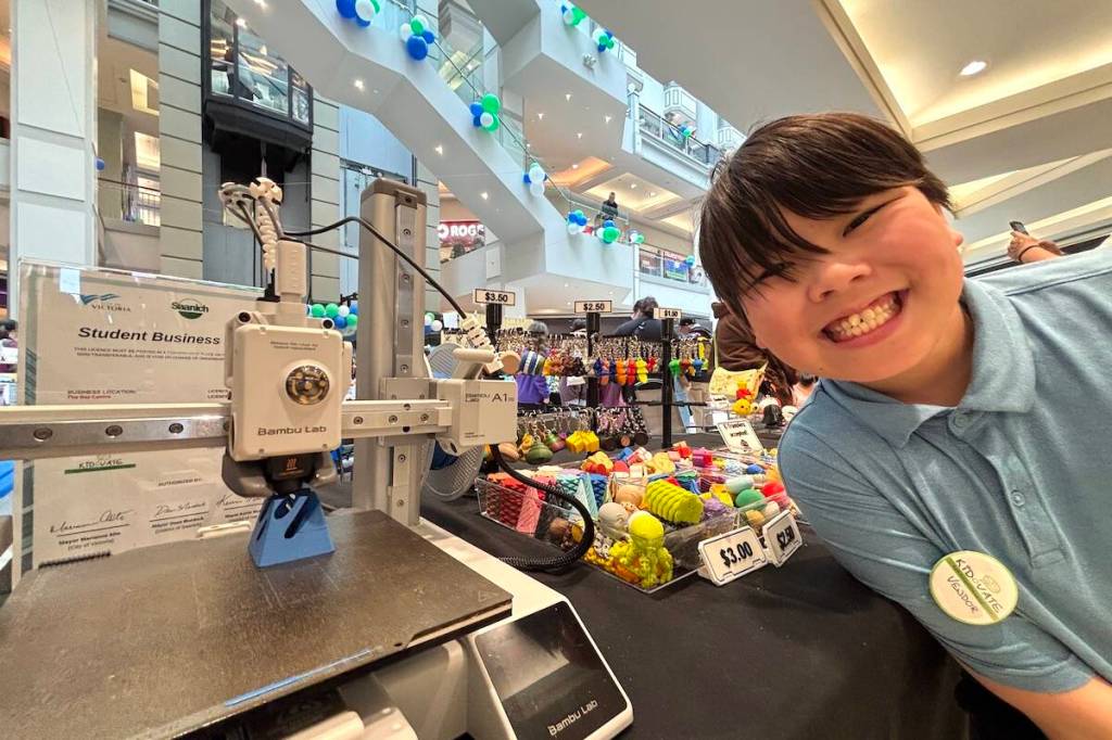 11-year-old Anders Yee shows off the 3D printer he used to make keychains and toys for the Kidovate market. (Liam Razzell/Victoria News)