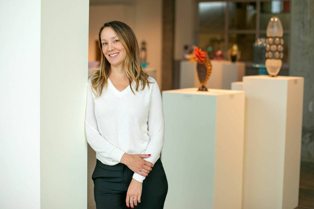 Raedle Alburn, the development and education director at Schack Art Center, stands in the Schack’s main gallery Thursday, Oct. 19, 2023, in Everett, Washington. Alburn is one of six recipients of the Washington Art Education Association awards. (Ryan Berry / The Herald)
