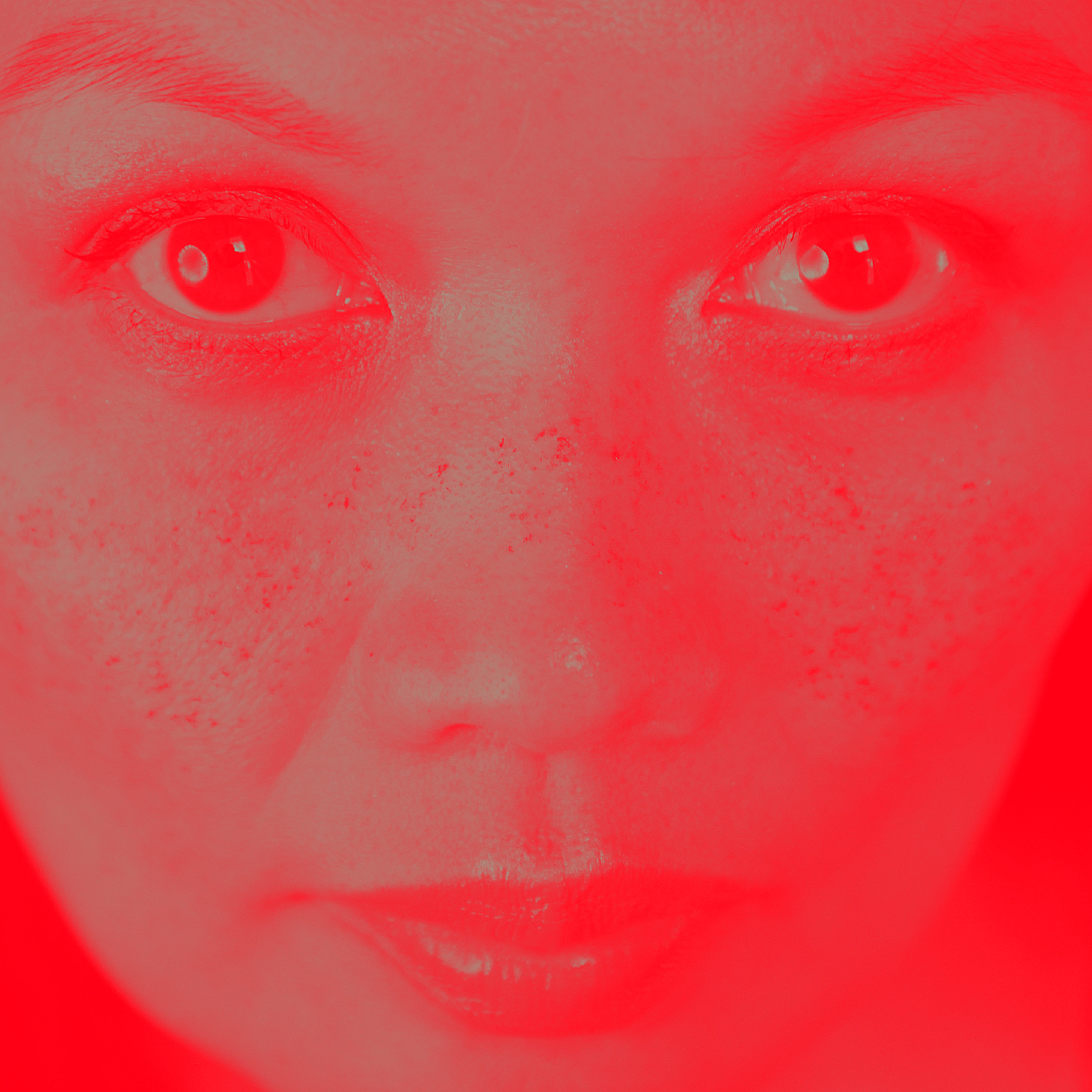 Cover of Red Sunset featuring a close-up of Bic Runga's face bathed in bright red light, highlighting her eyes and freckles.