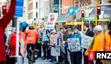 Human chain bike lane fills Wellington street objecting proposed cuts to infrastructure