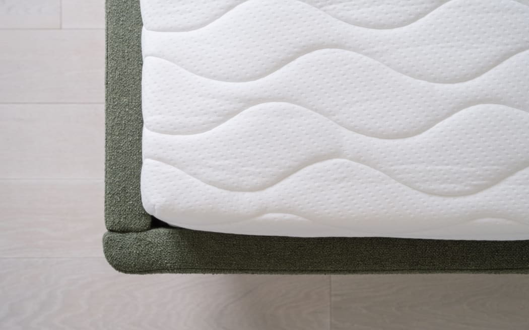 top view of new foam orthopedic mattress with white cotton surface on modern bed at home, comfort sleeping concept