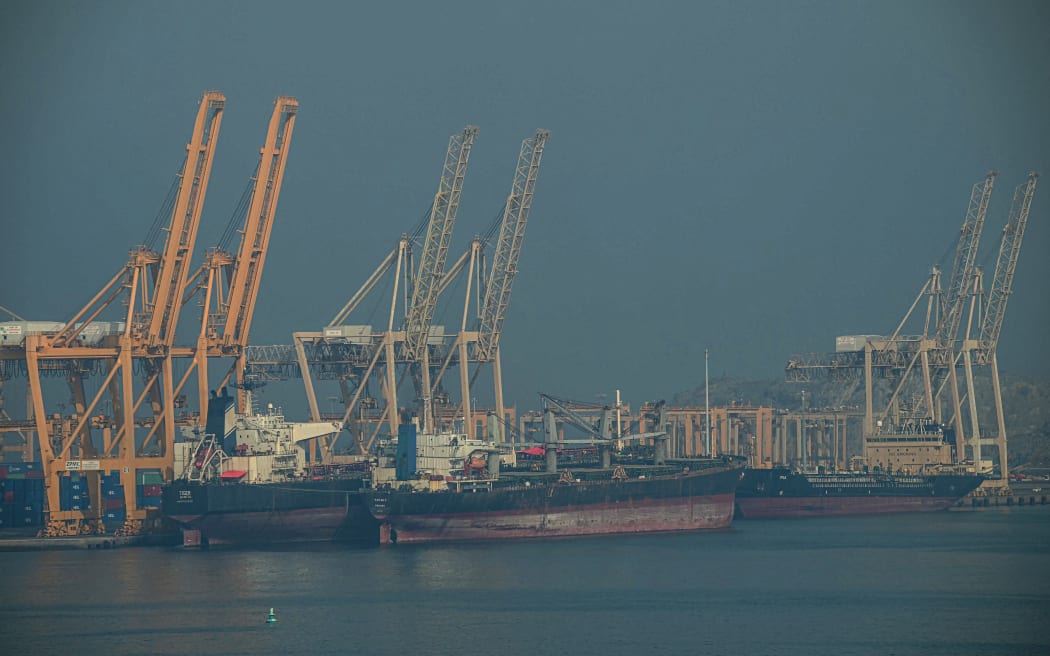 Tankers are seen at the Khor Fakkan Container Terminal, the only natural deep-sea port in the region and one of the major container ports in the Sharjah Emirate, along the Strait of Hormuz, a waterway through which one-fifth of global oil output passes on June 23, 2025. (Photo by Giuseppe CACACE / AFP)