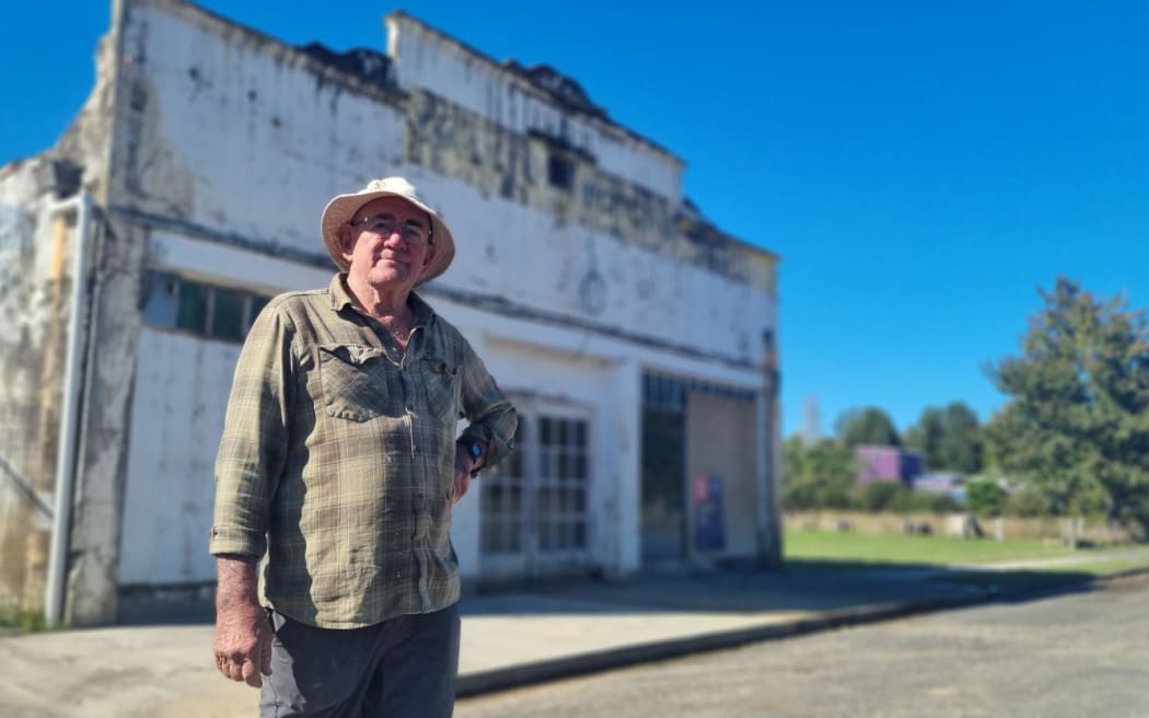 Stewart Mckenzie owns the Kallil Motors Building in Ōhura. Built in the 1920s, etched on its wall is a record of all the times floodwaters have entered the building.