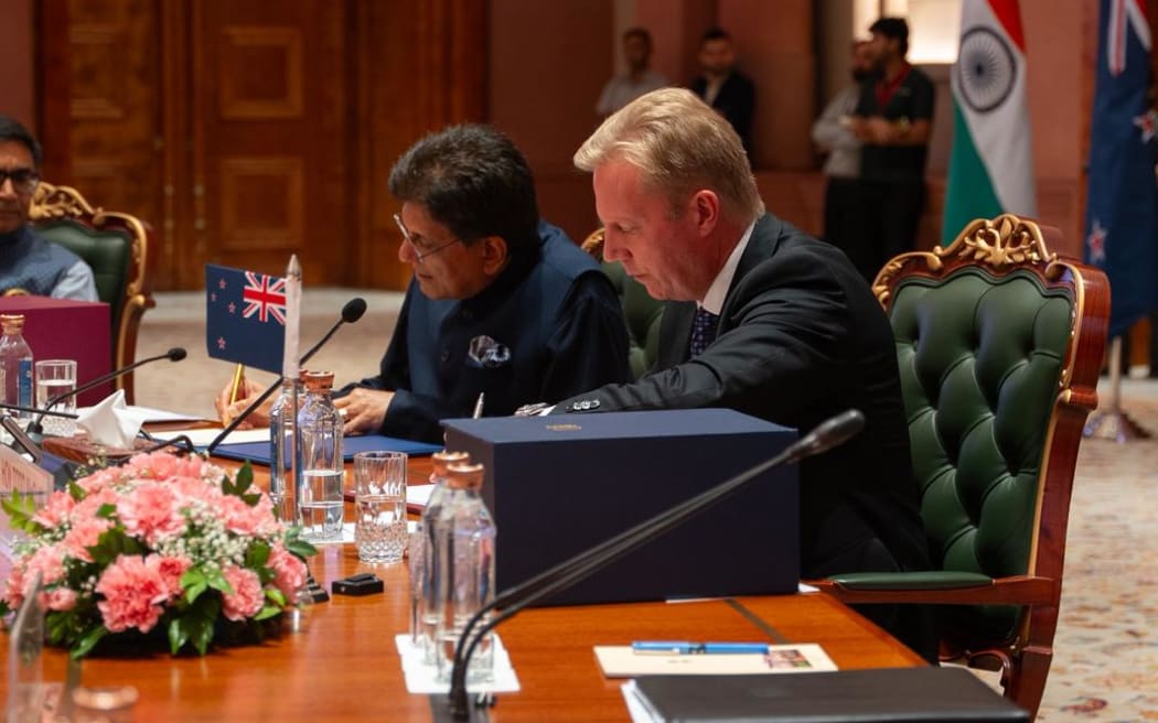 Indian Commerce and Industry Minister Piyush Goyal and New Zealand's Trade Minister Todd McClay sign the free-trade agreement.