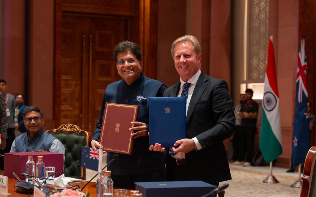 Indian Commerce and Industry Minister Piyush Goyal and New Zealand's Trade Minister Todd McClay sign the free-trade agreement.