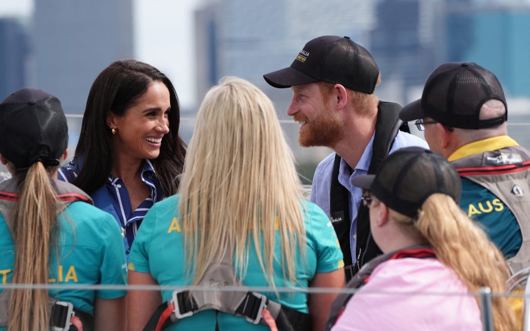 Britain's Prince Harry, Duke of Sussex, and his wife Meghan, the Duchess of Sussex, take part in a sailing event with members of Invictus Australia in Sydney Harbour on April 17, 2026. (Photo by Jonathan Brady / POOL / AFP)
