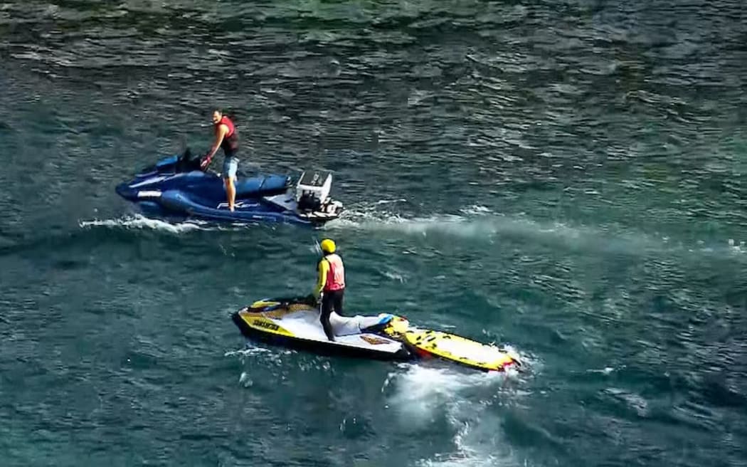 Shark surveillance drones and jet skis are patrolling the area.
