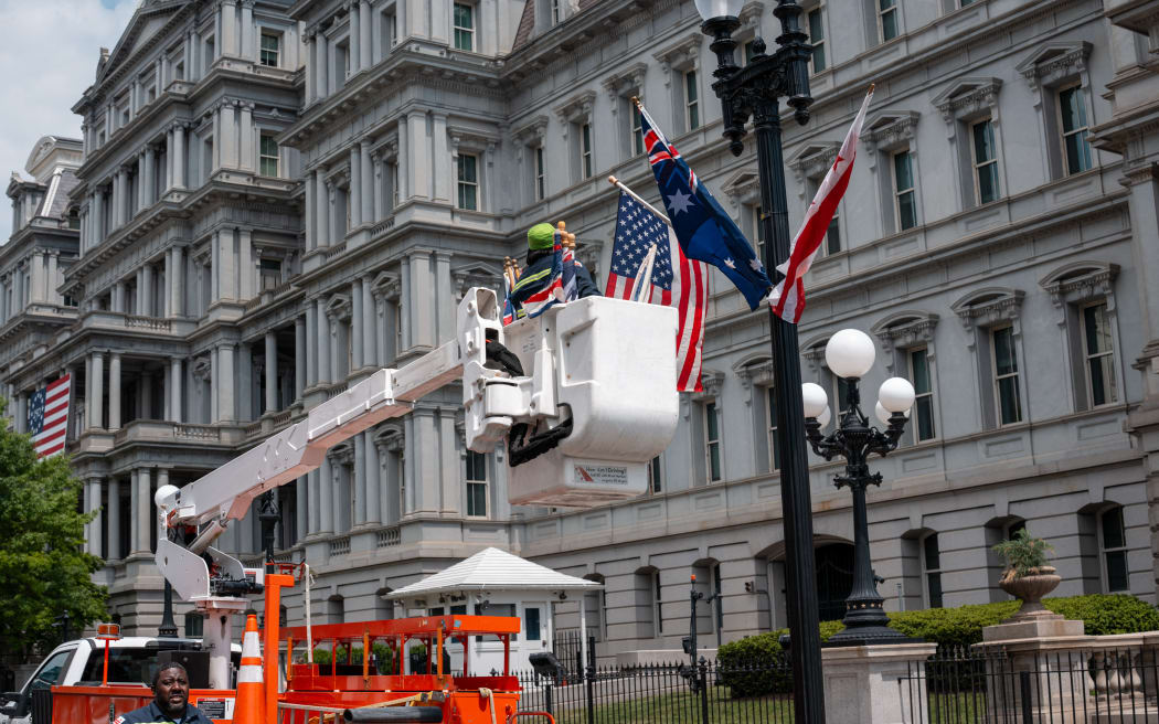 WASHINGTON, DC - APRIL 24: Local DC government workers replace the Australian flag with the Union Jack along 17th Street next to the White House on April 24, 2026 in Washington, DC. The DC government mistakenly placed both flags around the White House in preparation of King Charles visit to Washington on April 27, 2026. Andrew Leyden/Getty Images/AFP (Photo by Andrew Leyden / GETTY IMAGES NORTH AMERICA / Getty Images via AFP)