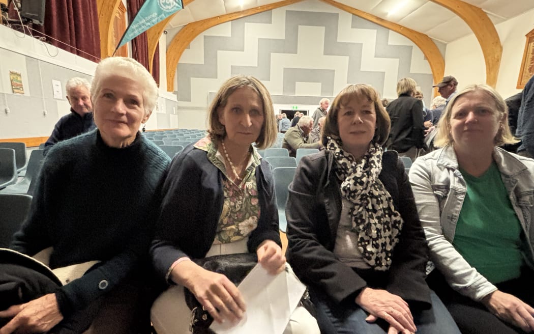 four women in a hall