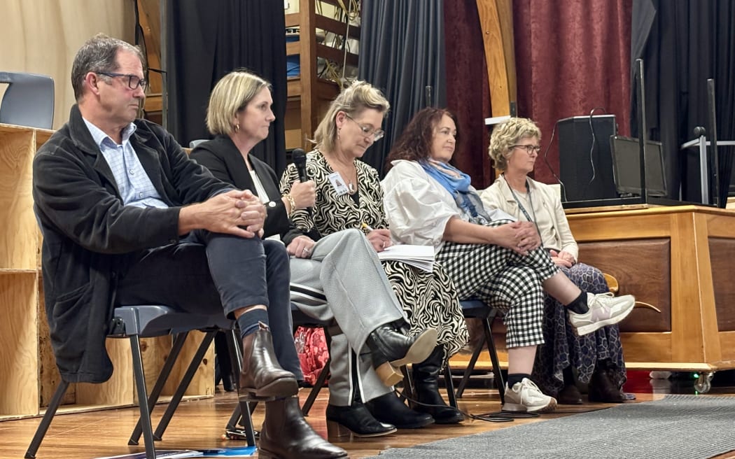 Dr Paul Watson, Health NZ; Kim Sinclair Morris, Pegasus Primary Health Organisation; Kathy O'Neill, Berni Marra and Sandy Clemett, Health NZ, on stage at the Darfield public meeting.