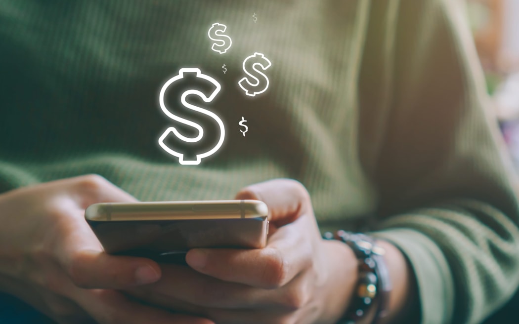Woman use gadget mobile phone earn money online with dollar icon pop up .Business technology on smartphone concept.