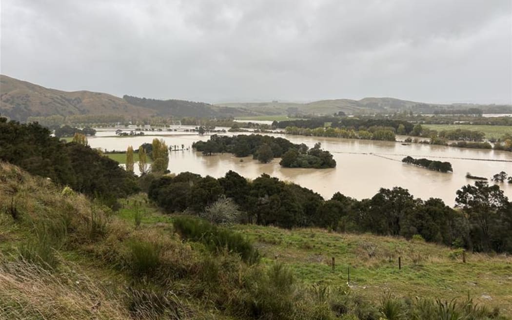 Flooded Ruamahanga River, taken from hillside at Morisons Bush looking down on the South Wairarapa. Pockets of native bush and windbreaks are now islands among flooded paddocks.