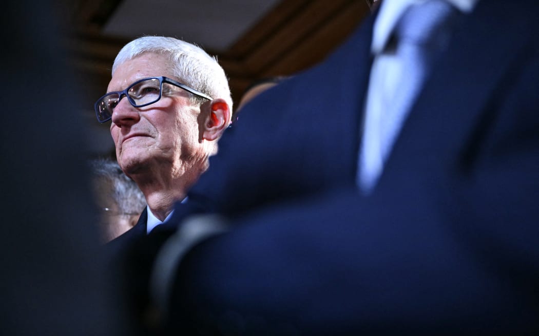 US businessman Tim Cook reacts during a reception with business leaders on the sidelines of the World Economic Forum (WEF) annual meeting in Davos on January 21, 2026. The World Economic Forum takes place in Davos from January 19 to January 23, 2026. (Photo by Mandel NGAN / AFP)
