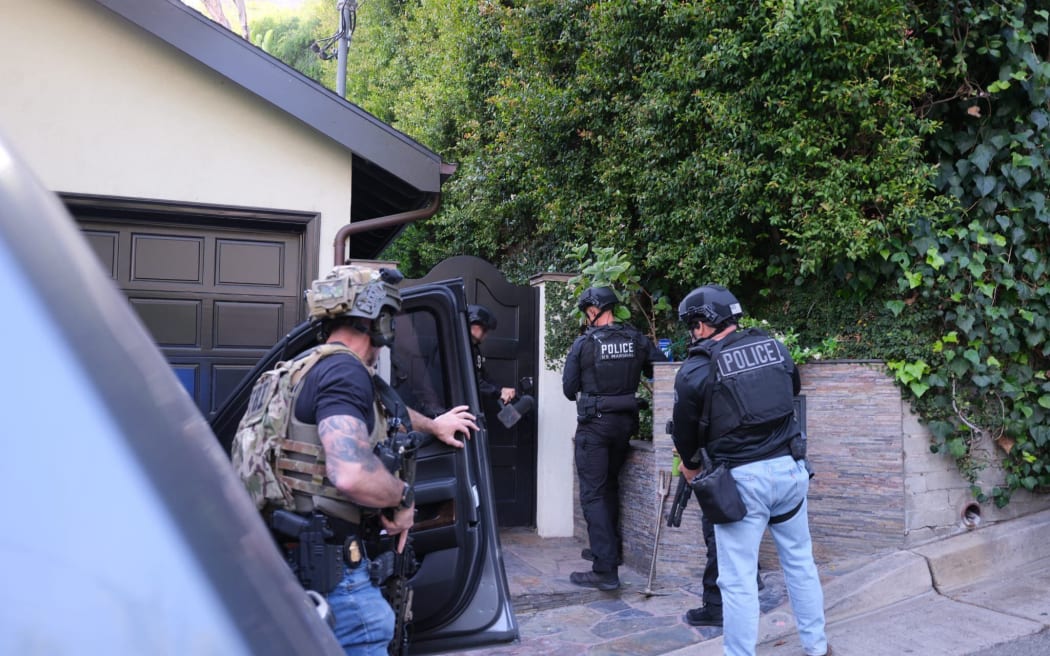 Photos posted by the Los Angeles Police Department show the operation that led to the arrest of singer d4vd – whose legal name is David Burke – on April 16, in the killing of a 14-year-old girl whose decomposed body was found in a car last year.
Mandatory Credit:	LAPD via CNN Newsource