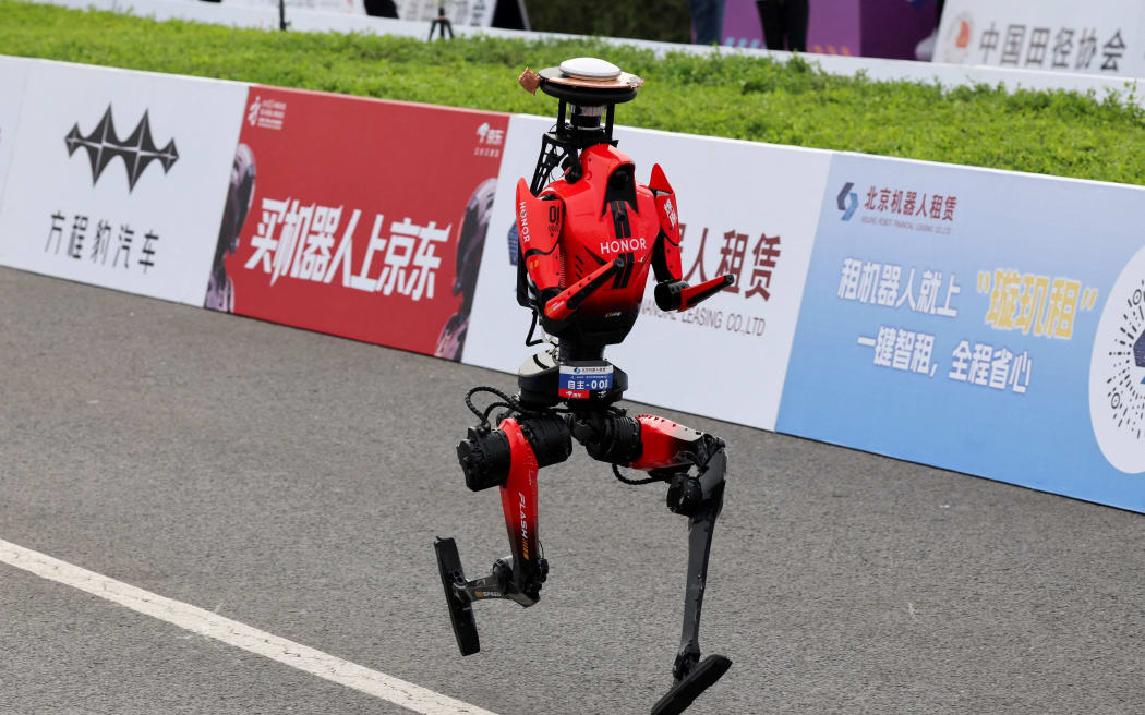 Humanoid robot Lightning runs after crossing the finish line.