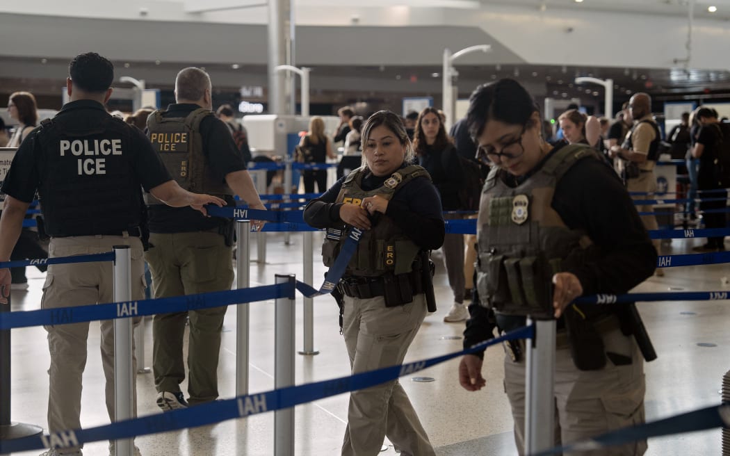 HOUSTON, TEXAS - MARCH 28: ICE agents enter the security line at George Bush Intercontinental Airport on March 28, 2026 in Houston, Texas. After House Republicans rejected a Senate-passed deal to fund Department of Homeland Security (DHS) subagencies including the Transportation Security Administration (TSA), President Trump issued an executive order on Friday instructing DHS to immediately pay TSA agents who have been working without pay for over 40 days.   Danielle Villasana/Getty Images/AFP (Photo by Danielle Villasana / GETTY IMAGES NORTH AMERICA / Getty Images via AFP)