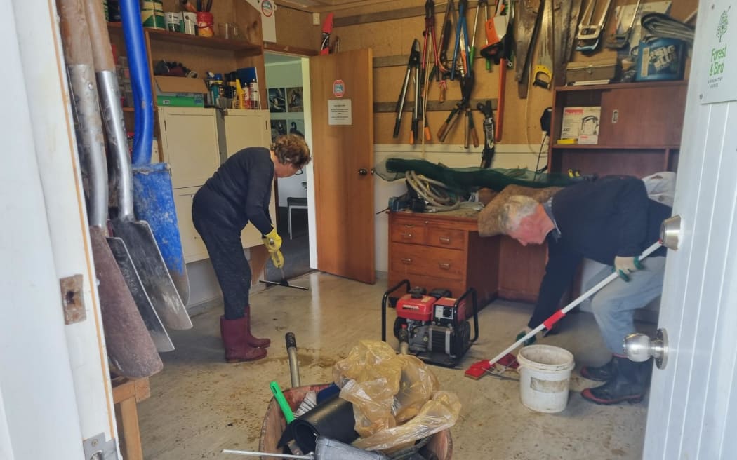 Volunteers cleaning up Forest & Bird Cottage in Pāuatahanui on Sunday 19 April, 2026, after flooding the day before.