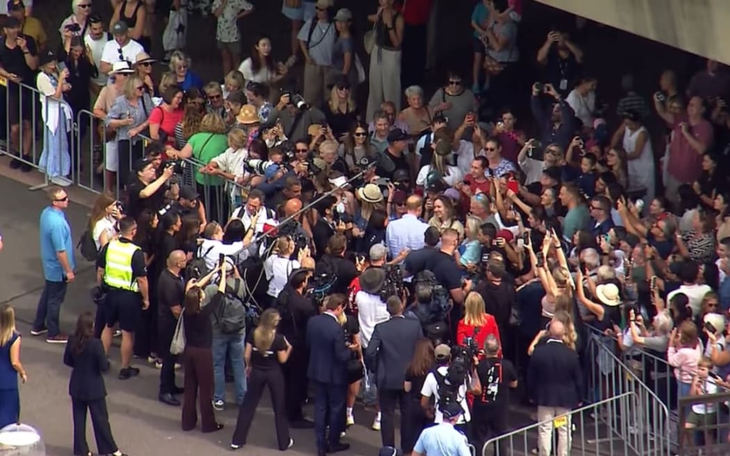 About 150 people greeted the Duke and Duchess of Sussex at the Sydney Opera House. (ABC News)