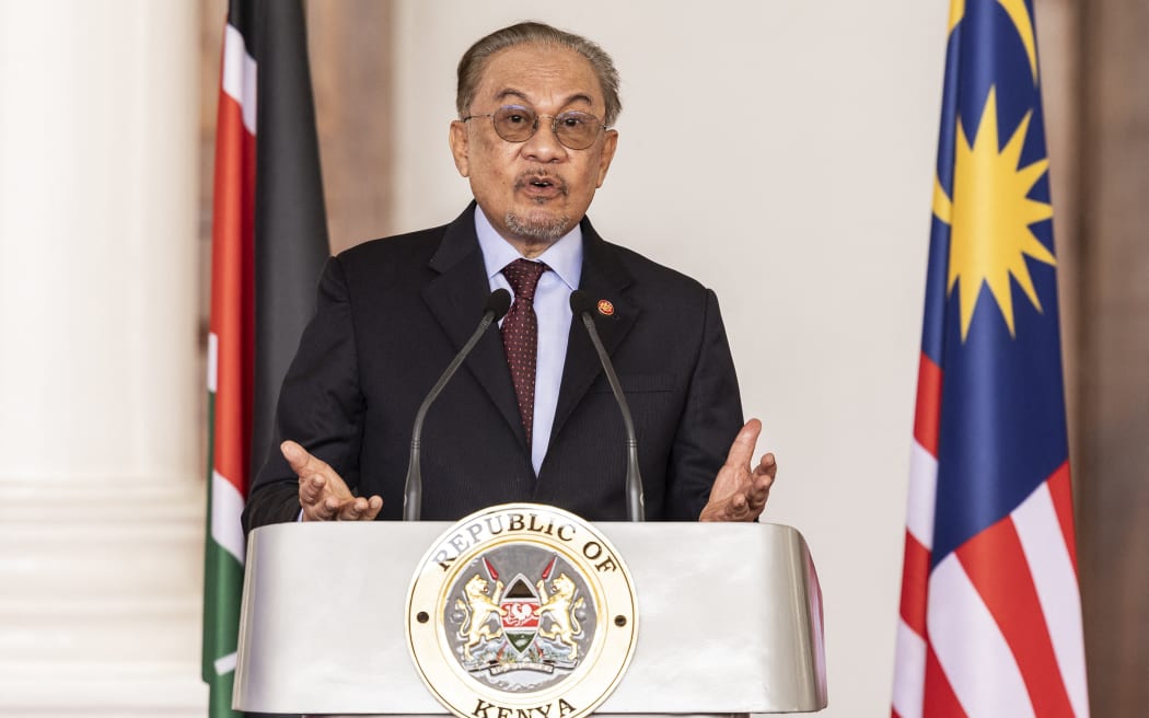 Malaysian Prime Minister Anwar Ibrahim gestures during a joint press conference with Kenya's President William Ruto (not in the picture), during his state visit at Statehouse in Nairobi, on November 24, 2025. (Photo by SIMON MAINA / AFP)