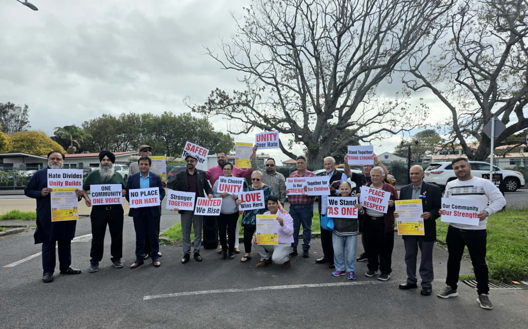 Members of the Indian community gather outside Papatoetoe Central School after graffiti inciting racial violence was found near the school last Saturday.