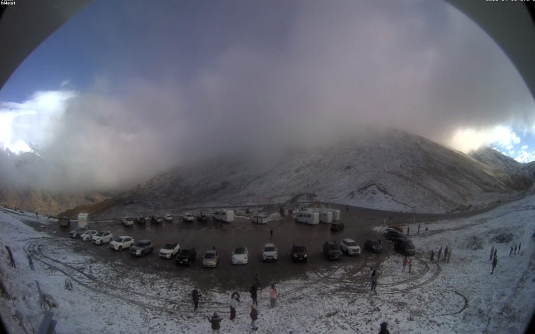 The NZTA Crown Range Webcam on Thursday morning showing snowfall near the road.