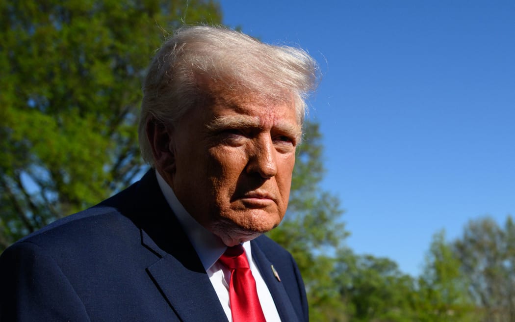 US President Donald Trump speaks with reporters prior to boarding Marine One as he departs from the South Lawn of the White House in Washington, DC, on April 11, 2026. President Donald Trump is on his way to Florida to attend an UFC event. (Photo by Mandel NGAN / AFP)