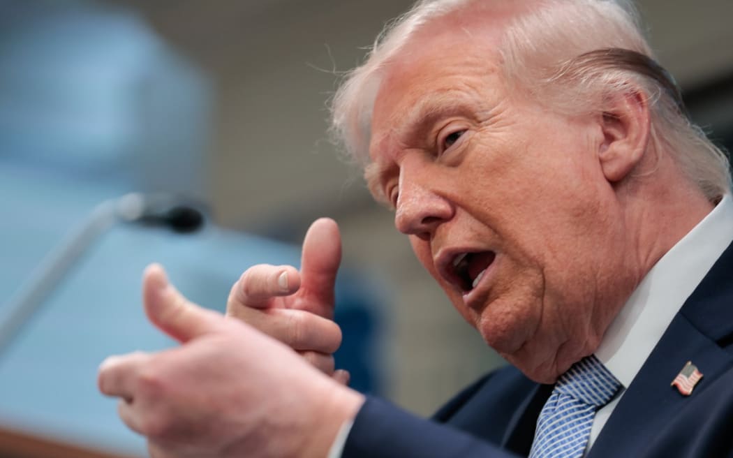 US President Donald Trump mimics firing a gun as he speaks about the conflict in Iran in the James S. Brady Press Briefing Room of the White House on April 6, 2026, in Washington, DC.