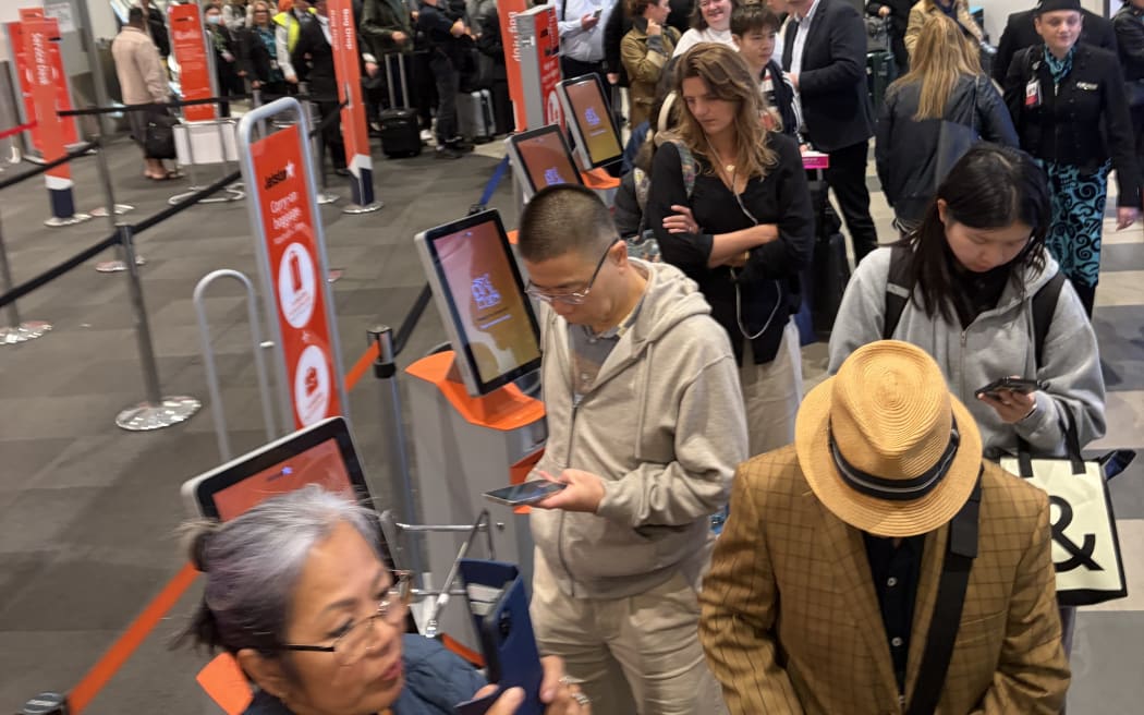 Queues were building at Auckland Airport after delays over bad weather and a security breach.