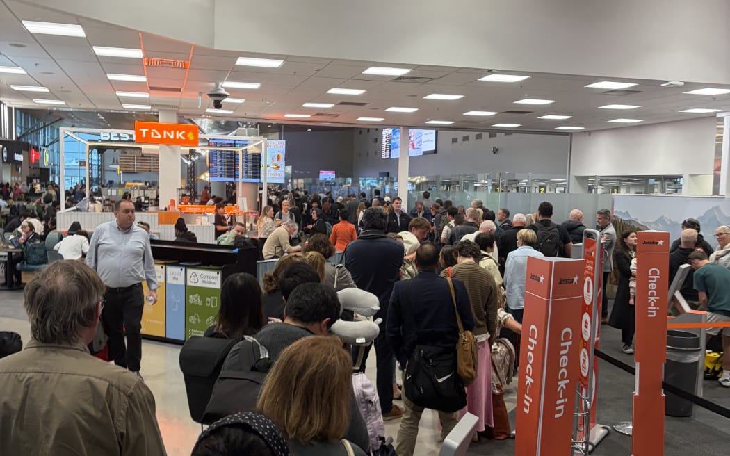 Queues were building at Auckland Airport after delays over bad weather and a security breach.