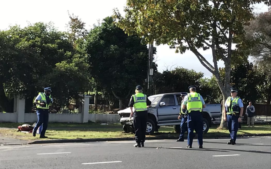 Police inspect the scene at the intersection of Poaka Avenue and Whatawhata Road.