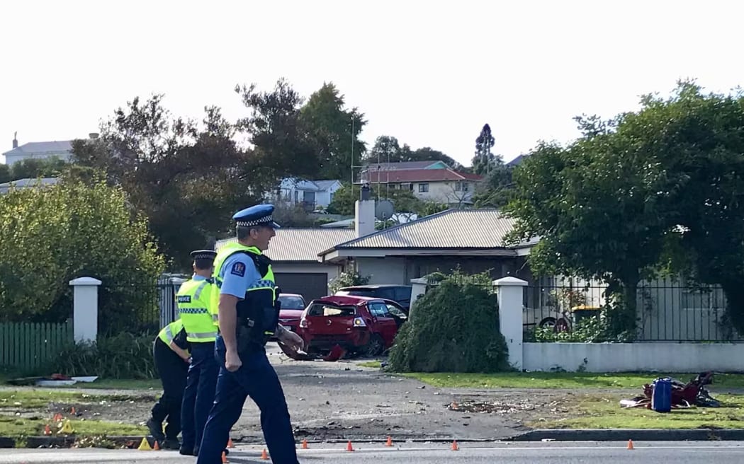 The man's car pictured in the driveway of a Whatawhata Rd property in Hamilton after he crashed into a ute, a pedestrian and then the property's iron gates.
