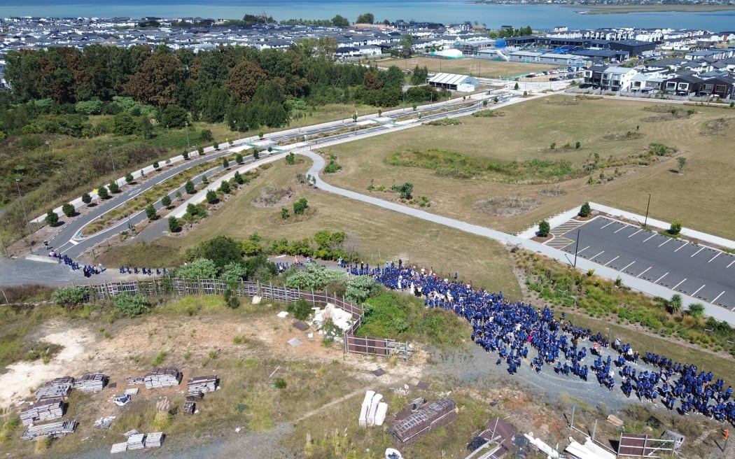 Students of Scott Point School standing at the incomplete road that could link Joshua Carder Dr to Squadron Dr.