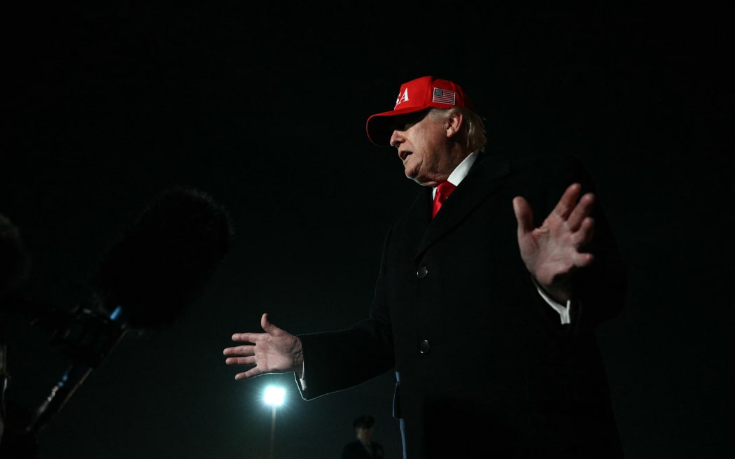 US President Donald Trump speaks to the press upon arrival at Joint Base Andrews in Maryland on April 12, 2026. Trump is returning to Washington, DC, after he attended a UFC event and spending the weekend at his Trump National Doral Miami resort. (Photo by Jim WATSON / AFP)